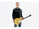 Chris Buck standing and holding his Signature Revstar RS02CB guitar